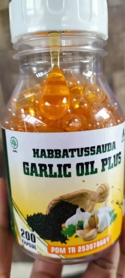 AI Video from prompt: A cinematic close-up of a habbatussauda oil bott
