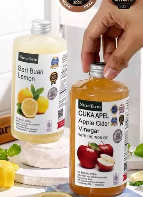 AI Video from prompt: A hand gently picks up a bottle of apple cider v