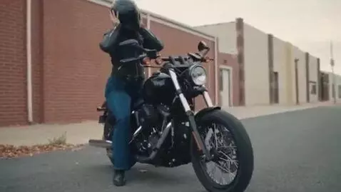 AI Video from prompt: a curvy woman on a motorcycle. she steps off and