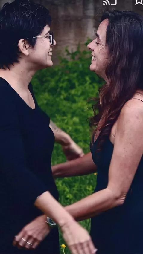 AI Video from prompt: An attractive man hugs the two women