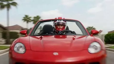 AI Video from prompt: This racer, driving a sports convertible, is rac