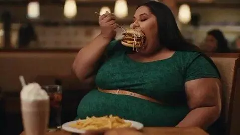 AI Video from prompt: a slim Indian woman in a dress. clips of her eat