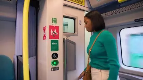 AI Video from prompt: Make a lady sitting on the train and touching he