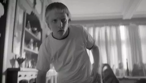 AI Video from prompt: Gritty B&W Scenescape Lifting face from being on