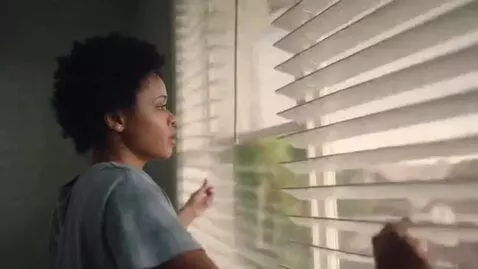 AI Video from prompt: A woman wakes, turns off her alarm clock, and wh