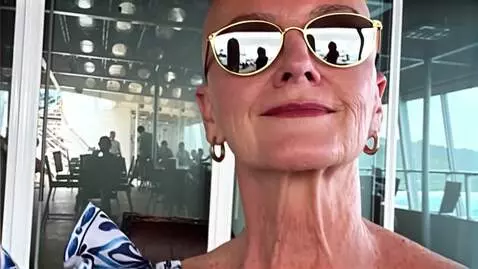 AI Video from prompt: The woman stands up and smiles
