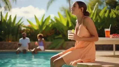 AI Video from prompt: Latina at a pool. breast expansion, she becomes 
