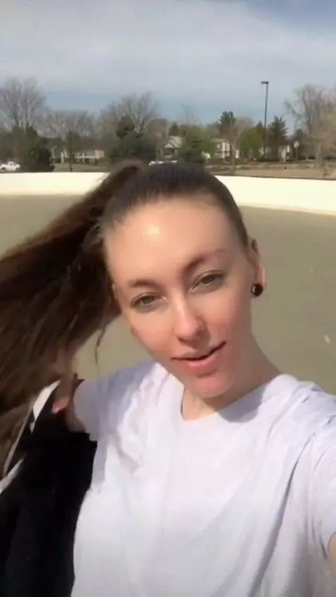 AI Video from prompt: Girl takes the jacket off and flicks her ponytai