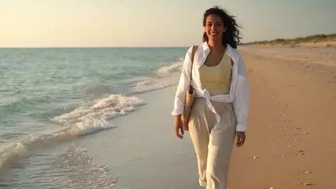 AI Video from prompt: a woman at the beach. enormous breast expansion