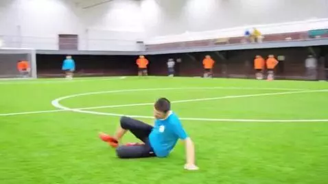 AI Video from prompt: This man kicks the ball, but misses and falls, s
