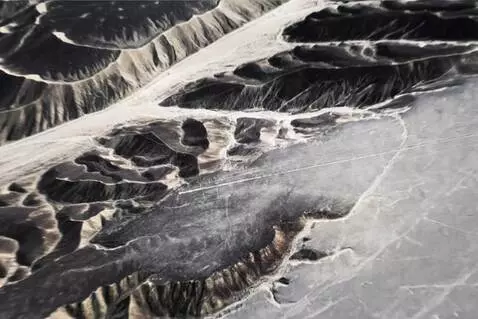 AI Video from prompt: Epic overhead shot of Nazca geoglyph glowing fai