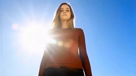 AI Video from prompt: Image of a gigantic young woman. The camera zoom
