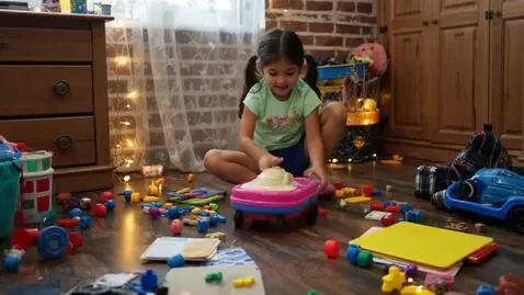 AI Video from prompt: A girl, playing in a cluttered room.