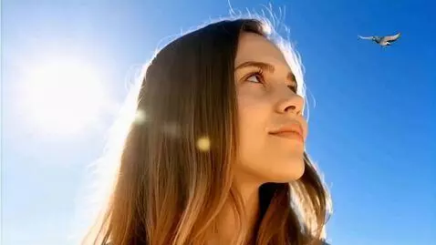 AI Video from prompt: Image of the serene face of a giant young woman.