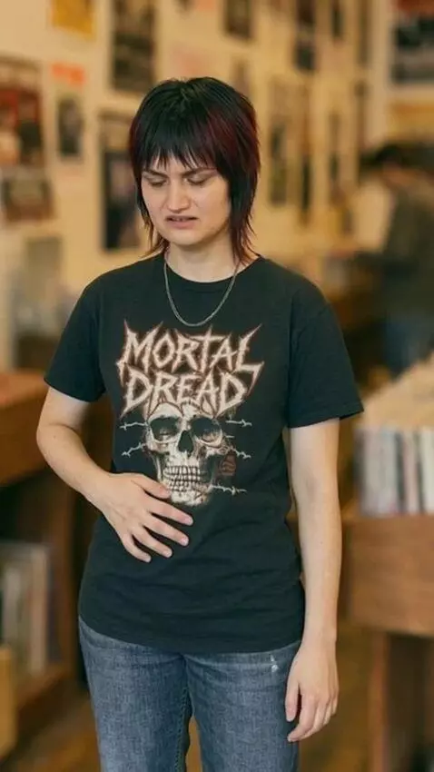 AI Video from prompt: Mackenzie suddenly feels very bloated. She rubs 