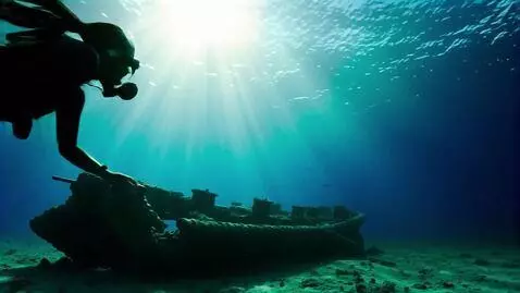 AI Video from prompt: Underwater shot: Lara Croft in black diving suit