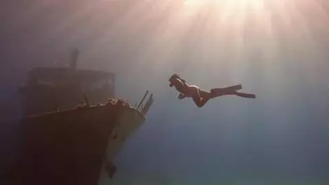 AI Video from prompt: Underwater shot: Lara Croft in black diving suit