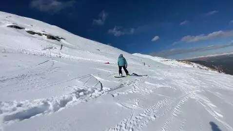 AI Video from prompt: A snowboarder rides a snowboard on the snow