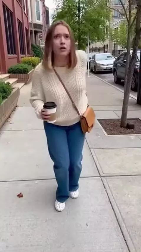 AI Video from prompt: Open on a white woman walking on a sidewalk. She