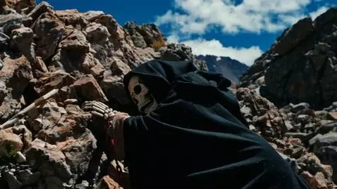 AI Video from prompt: A black hooded weathered and weary old death ske