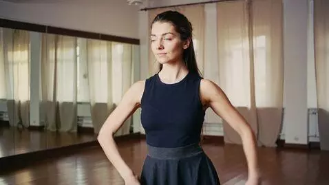 AI Video from prompt: she stands dancing and turns