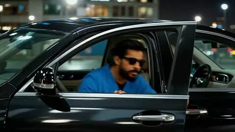 AI Video from prompt: Anees bhai parks the luxury black car beside a m