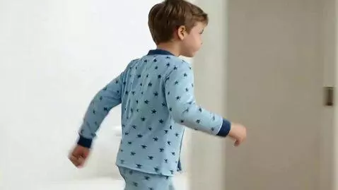 AI Video from prompt: He goes from the shower to the kitchen to have b
