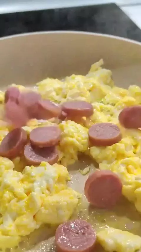 AI Video from prompt: You cook it in a frying pan, then add sausage to