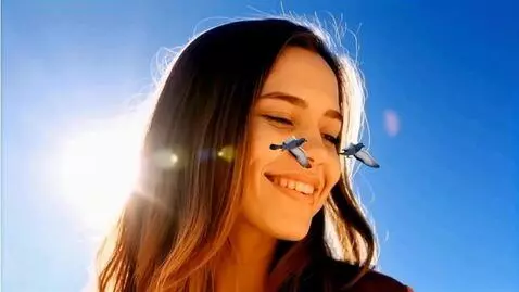 AI Video from prompt: Fixed image. A giant young woman smiles at two t