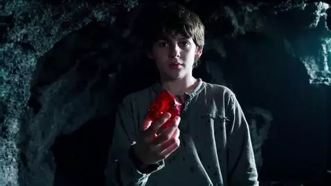 AI Video from prompt: A boy a boy is holding a gem and becomes a red d