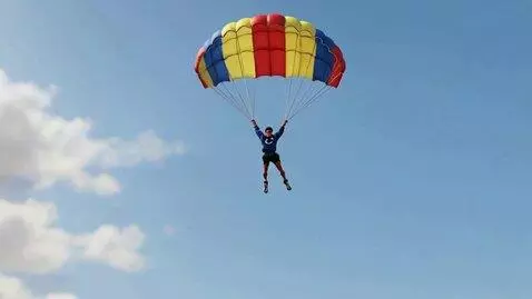 AI Video from prompt: A skydiver, having jumped out of an airplane, la