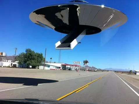 AI Video from prompt: a shiny metalic saucer shaped crant lands in the