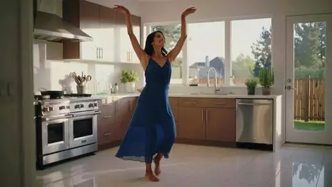 AI Video from prompt: Nice lady in blue dress dancing in the kitchen