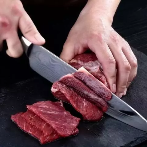 AI Video from prompt: A man cuts meat