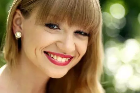 AI Video from prompt: girl smiles and winks at camera