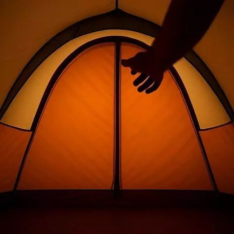 AI Video from prompt: Interior of a dimly lit tent. The camera focuses