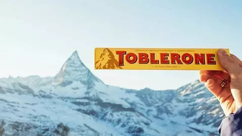 AI Video from prompt: move hand and chocolate "toblerone"  slowly to t