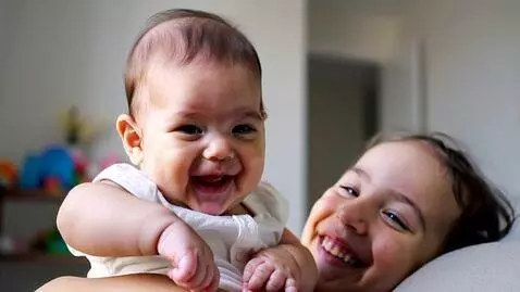 AI Video from prompt: A baby having a happy moment with a beautiful mo