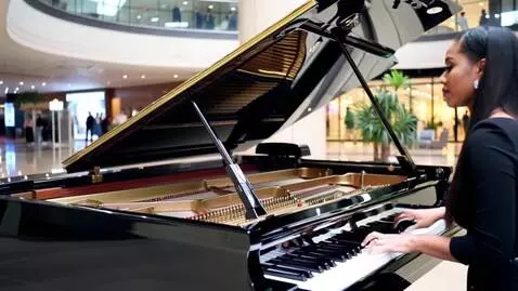 AI Video from prompt: A black beautiful lady playing the piano in  a s
