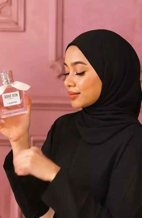 AI Video from prompt: A graceful woman in a black hijab sits elegantly