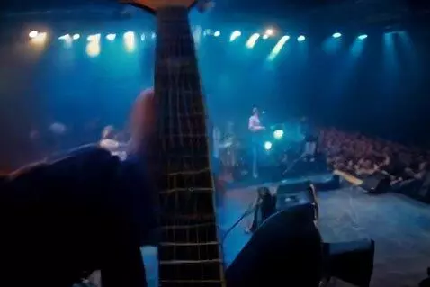 AI Video from prompt: A first-person POV video of a rock band guitaris