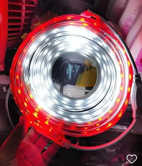 AI Video from prompt: A hand displays a coiled LED strip glowing inten