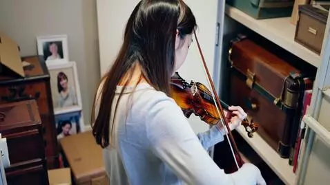 AI Video from prompt: A young violinist finds an antique instrument in