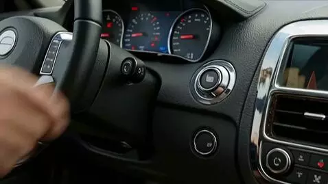AI Video from prompt: The driver's hand starts this convertible, his f
