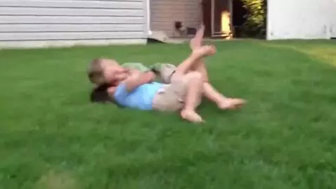 AI Video from prompt: Toddler boys fight,barefoot,clinch and roll over