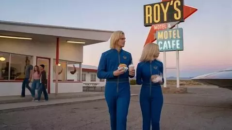 AI Video from prompt: the E.T. couple leave the desert cafe with their