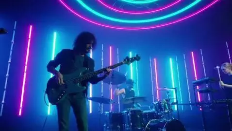 AI Video from prompt: A rock band is performing at a concert, with neo