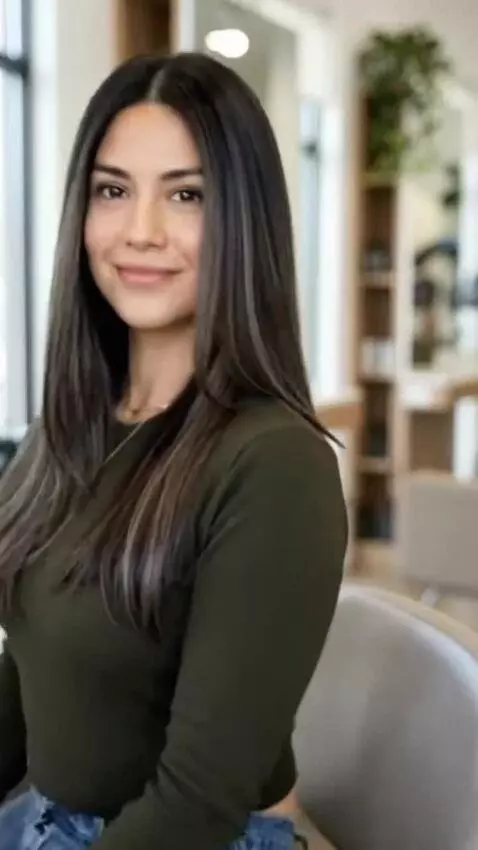 AI Video from prompt: A woman smiles gently at the viewer, holding eye