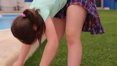 AI Video from prompt: girl wearing a skirt with wet hair, bends over s