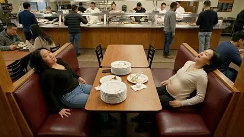 AI Video from prompt: Two Asian American women are sitting in a buffet